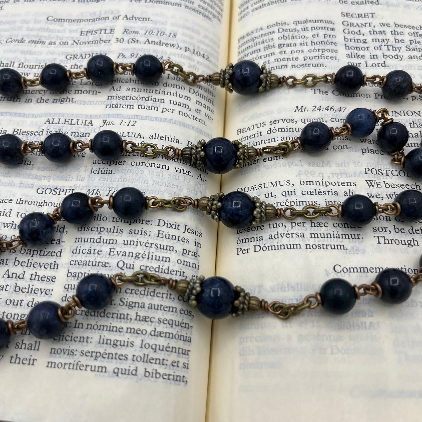 Close up of 10mm Dumortierite Our Father beads with bronze bead caps on hand wired heirloom rosary