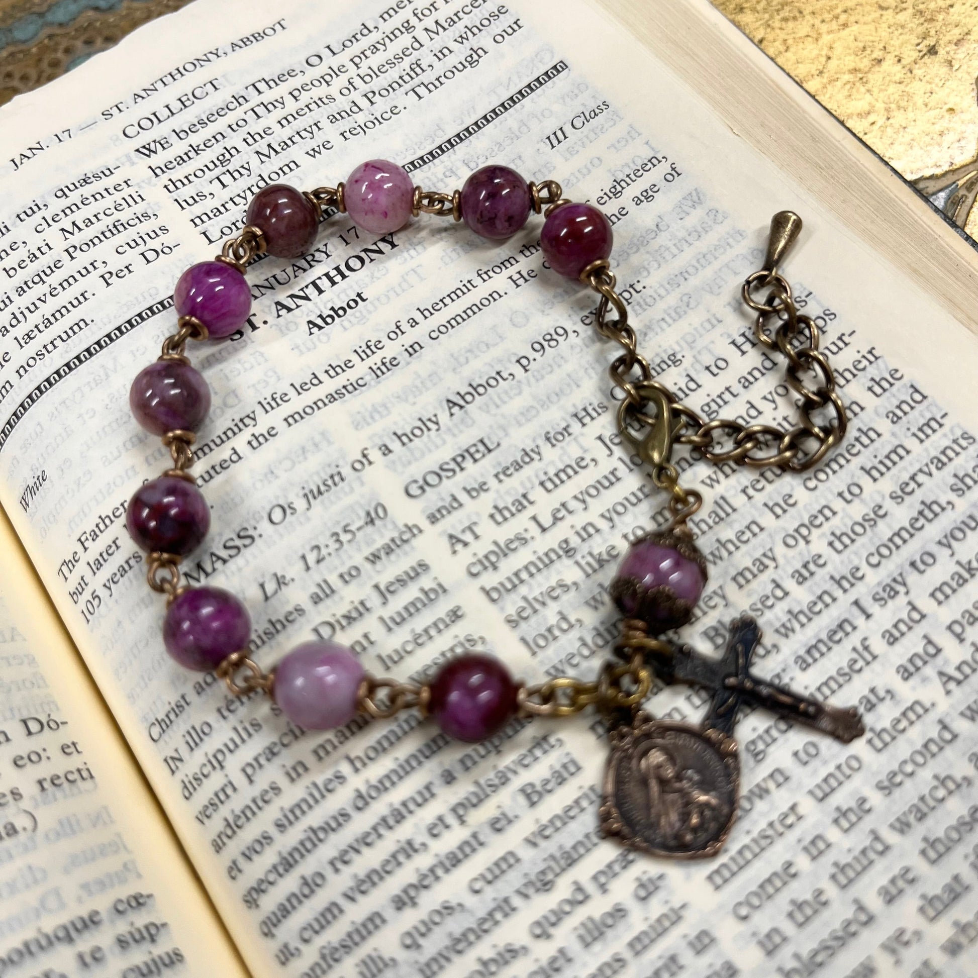 Catholic gemstone bracelet featuring solid bronze crucifix and medal detail