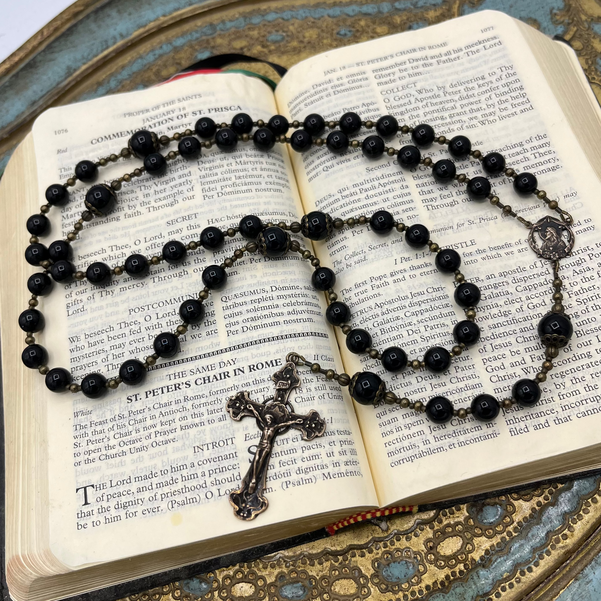 Bronze Black Rosary on open prayer book with Black onyx natural gemstones 