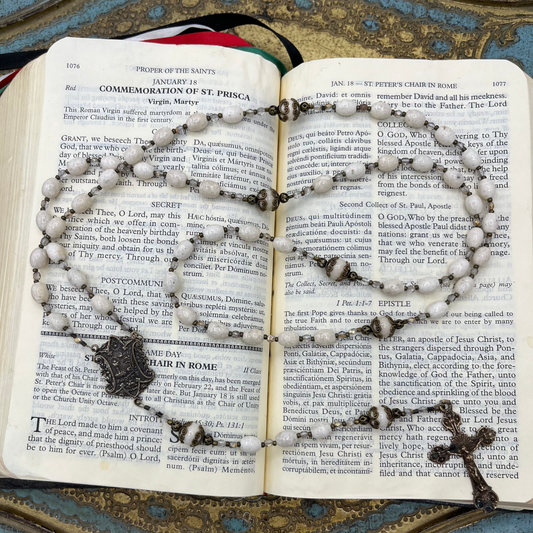 Close-up of Riverstone gemstone beads on a handmade Catholic rosary featuring solid bronze crucifix and center medal in a traditional Old World design.