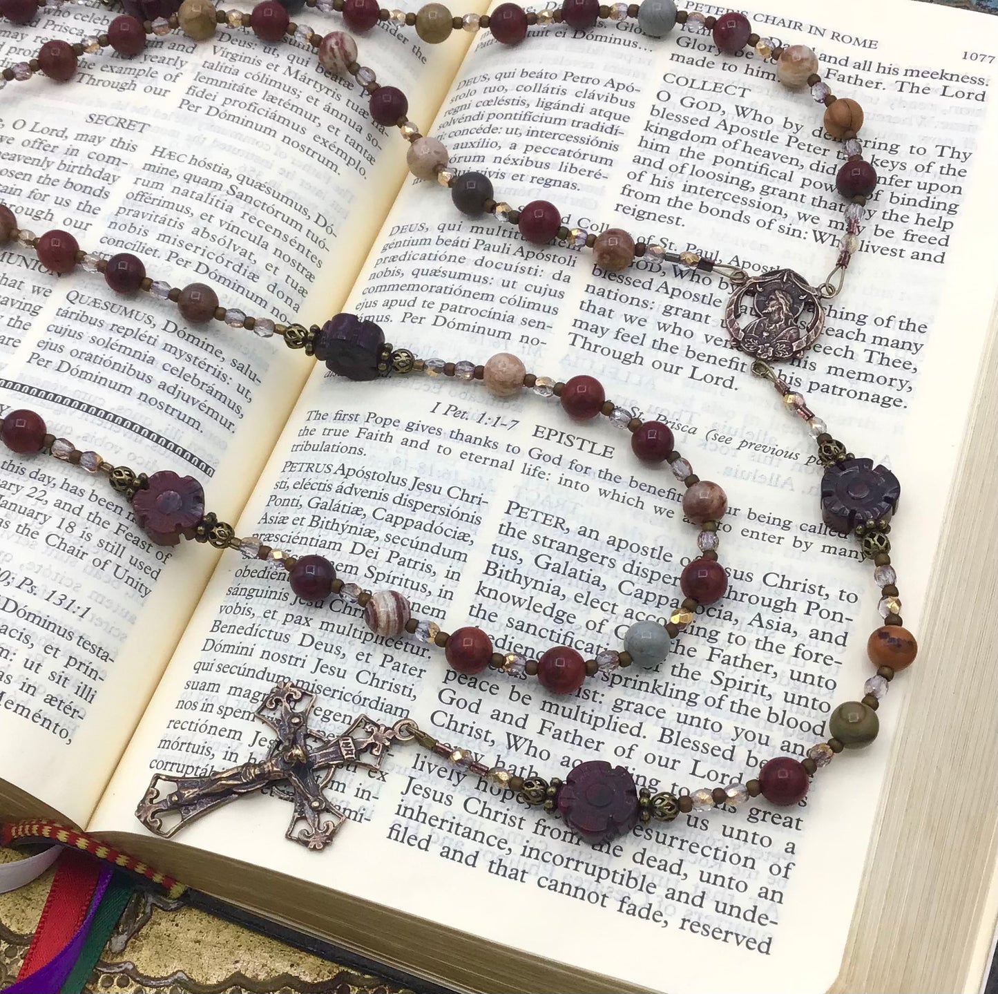 Close-up of natural Red Rainbow Jasper gemstone Hail Mary beads on handmade Catholic rosary