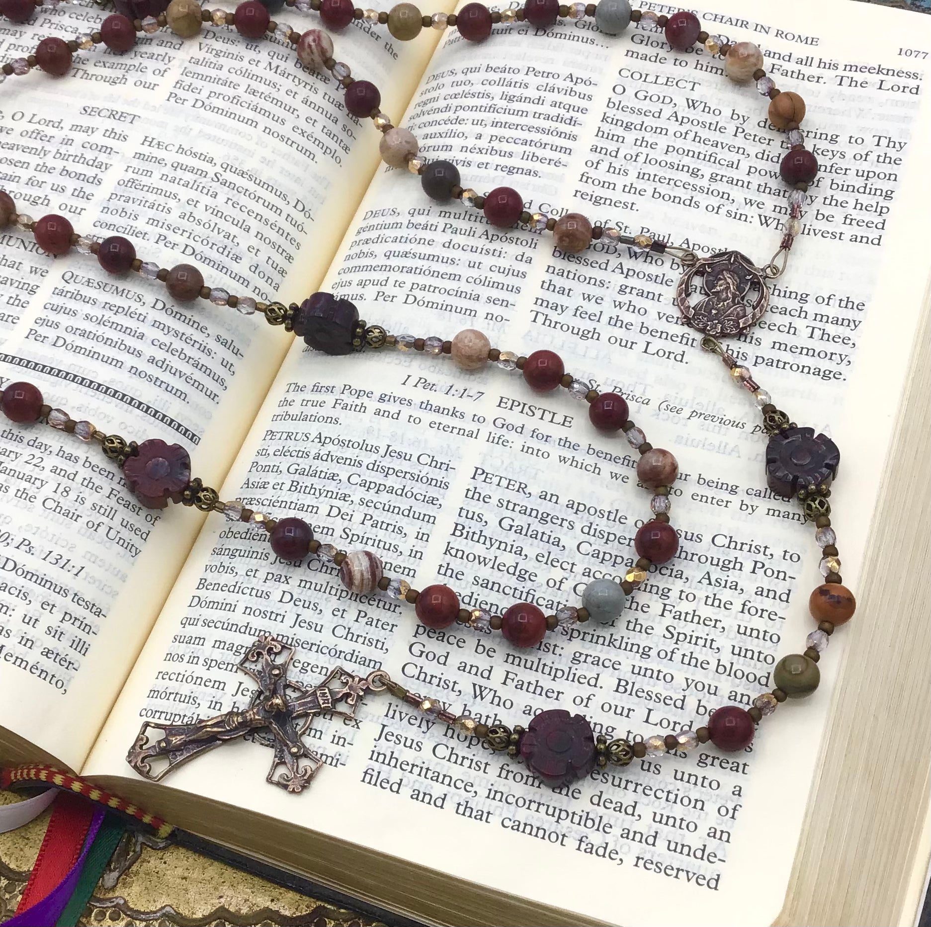 Close-up of natural Red Rainbow Jasper gemstone Hail Mary beads on handmade Catholic rosary